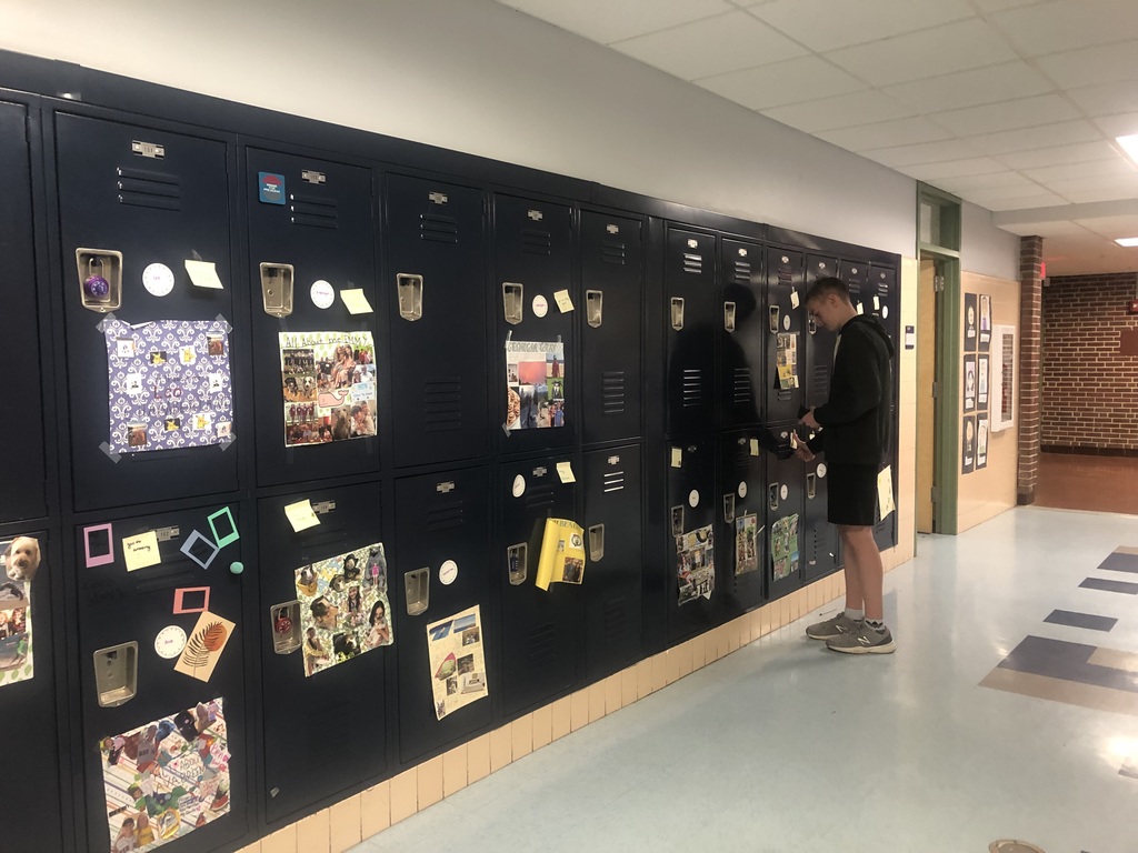 Student adding positive notes to lockers