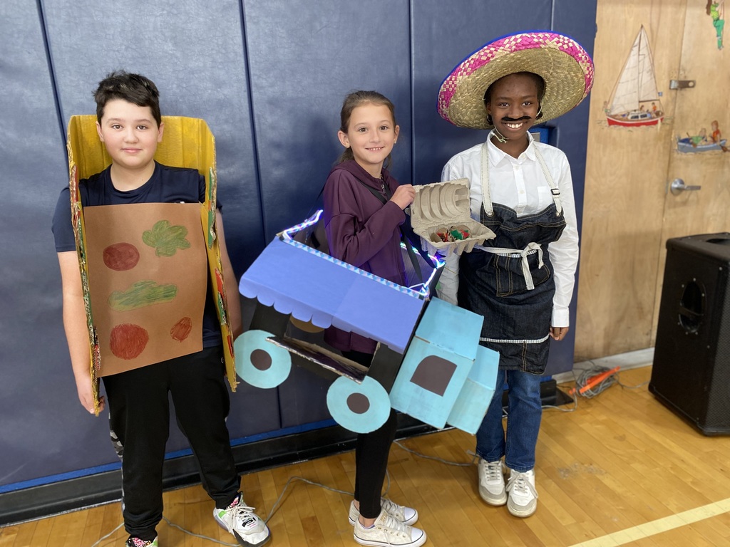 Students dressed as a taco, a taco truck and food service worker