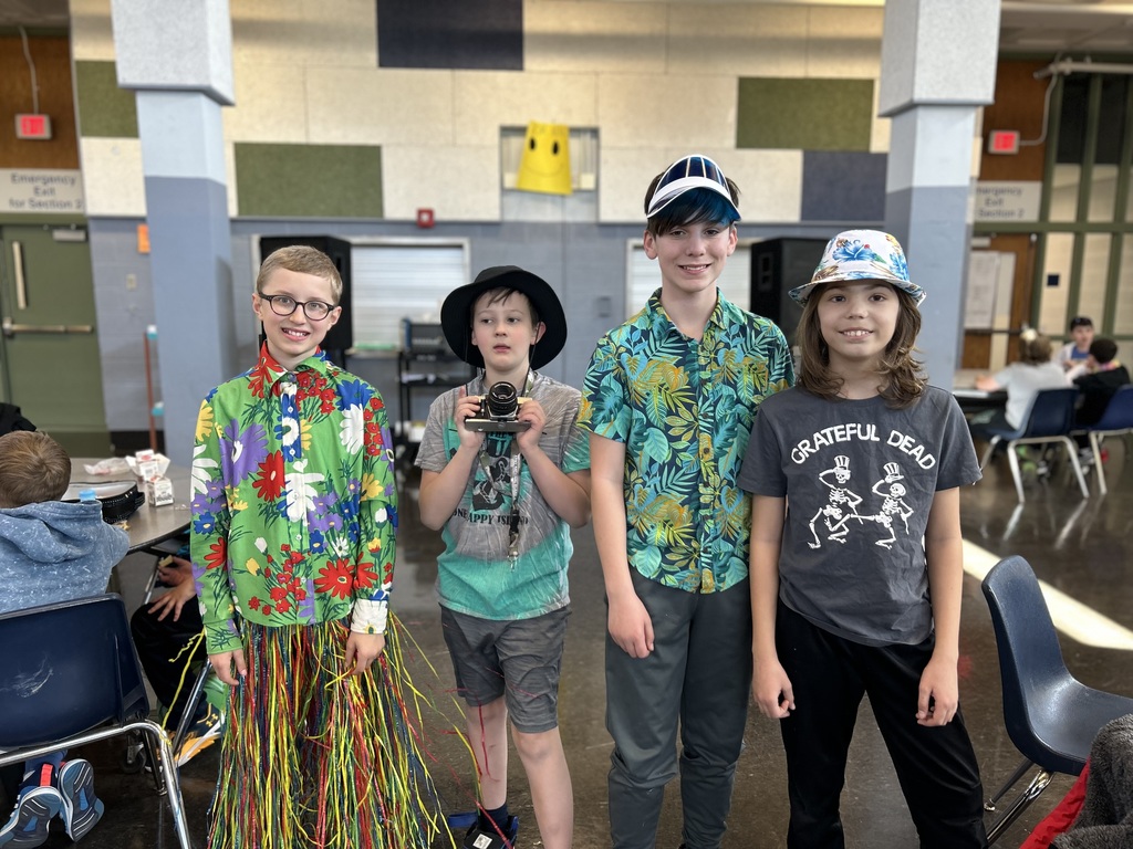 Four students dressed in tourist gear